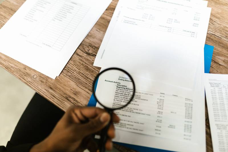 Reviewing a printed document with a magnifying glass